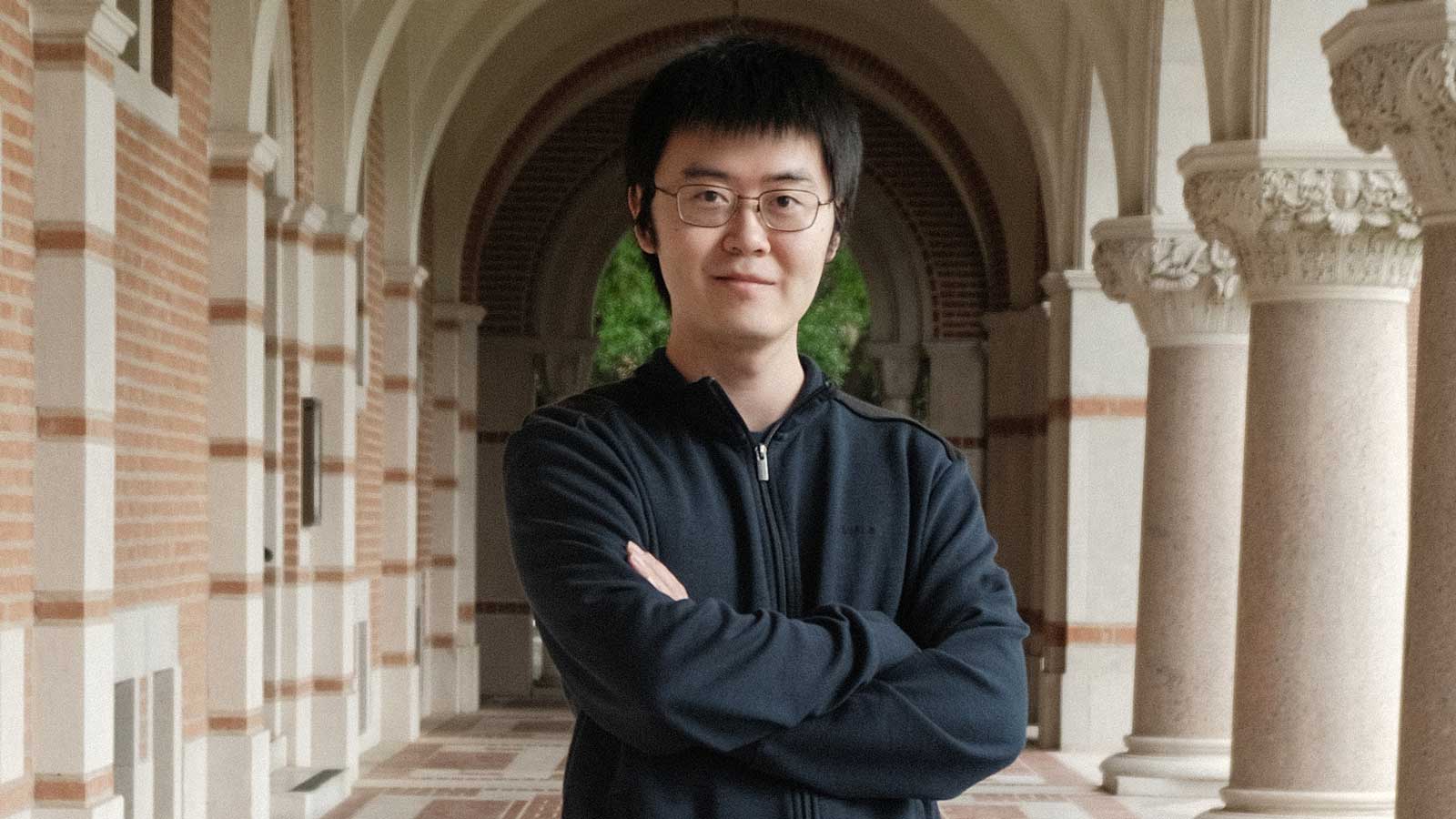 Charlie Liu standing with arms crossed