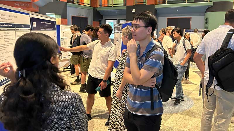 Student reading research poster